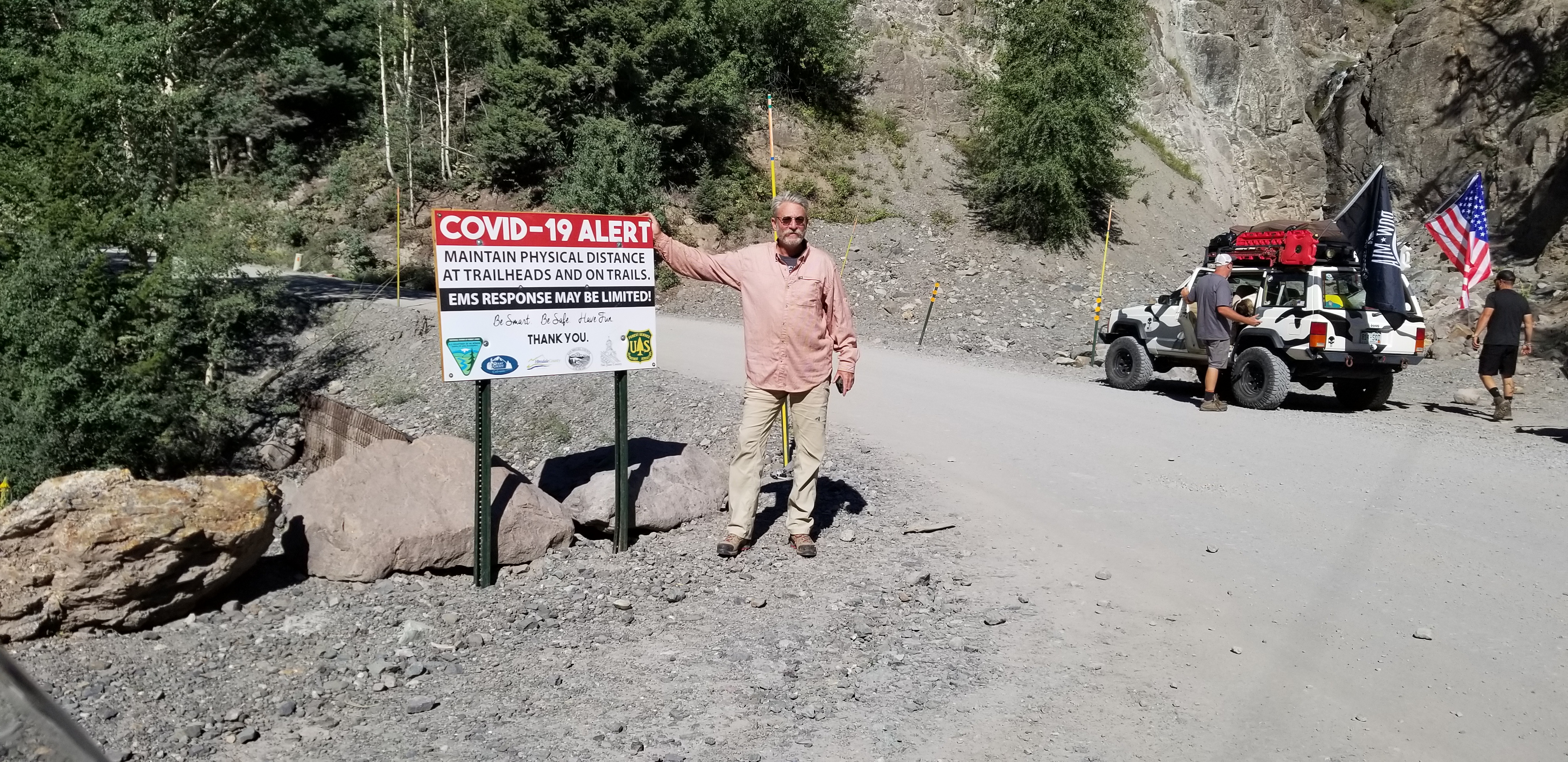 Pic of Fred next to a COVID-19 sign.